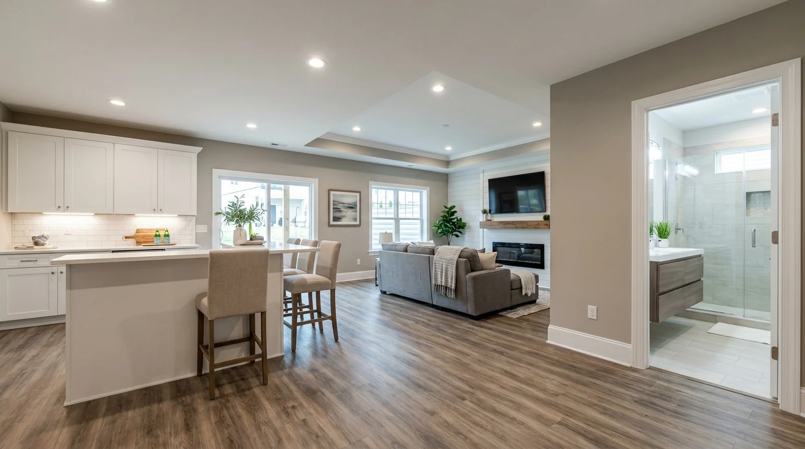 Family room, kitchenette & full bath — finished basement design concept by AmeriPro Remodeling